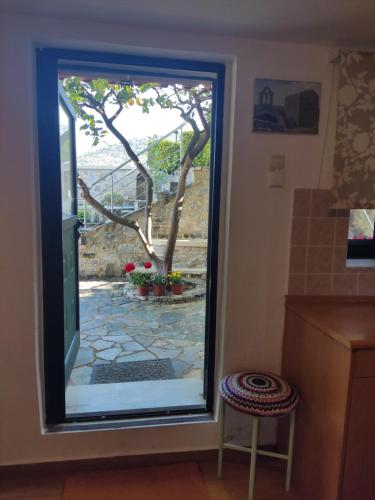 a window in a kitchen with a view of a garden at Palataki in Kardamili