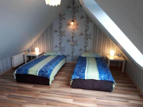 two beds in a room with a staircase at Holiday Apartment Evers 1 in Wittmund