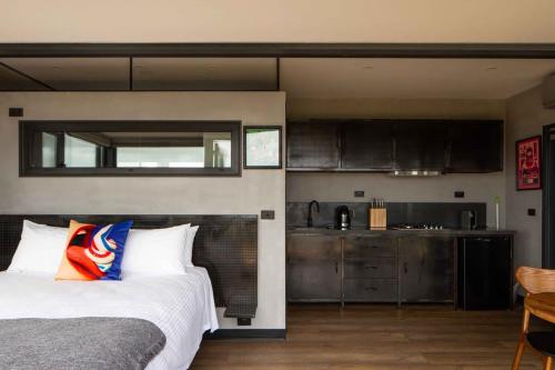 a bedroom with a bed and a kitchen at Sky Ship 1 - Luxury Off-Grid Eco Accommodation in Cape Otway