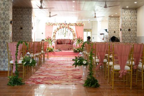a banquet hall with chairs and a room with a table at The Neeraj Naturecure On Ganga in Rishīkesh