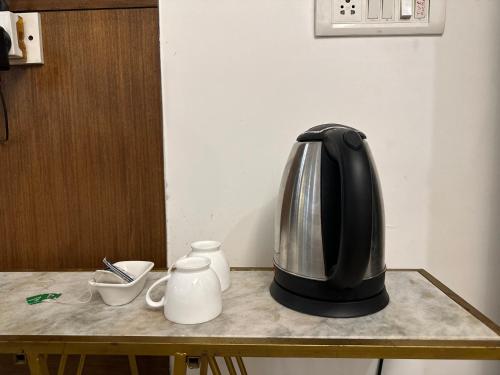 a coffee maker sitting on top of a table at Hotel Classic-Near Nizamuddin Railway Station in New Delhi