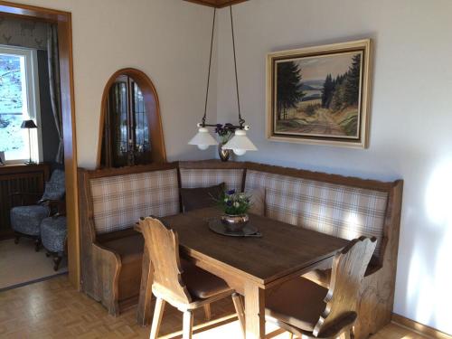 a dining room with a wooden table and chairs at Holiday home Waldhaus am Burbach in Bad Berleburg