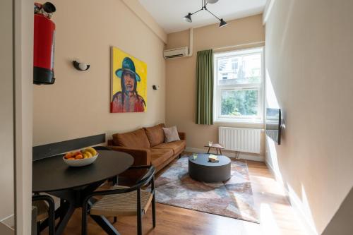 a living room with a table and a couch at Amsterdam Dockside Flats in Amsterdam