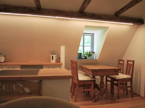 a kitchen with a table and chairs and a desk at Chic Apartment in Thuringia with Sauna in Hamma