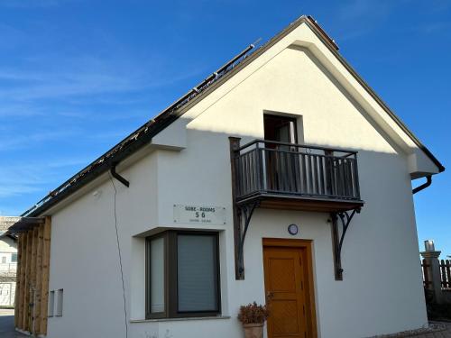 a white house with a balcony and a door at B&B Villa Angelina in Rogaška Slatina