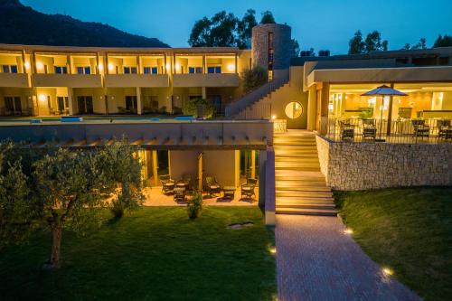 a house with a staircase leading up to it at night at Is Molas Resort in Pula