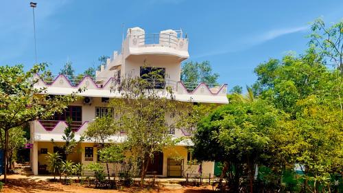 un edificio con balcón en la parte superior en Lotus Garden - Near Matrimandir Center Auroville, en Auroville