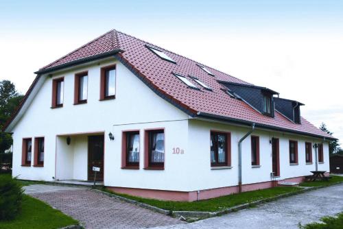 a white house with a red roof at Holiday village on the Baltic Sea Wohlenberg in Wohlenberg