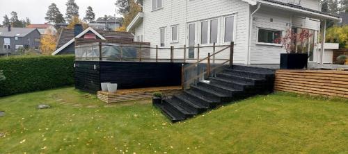 a house with a deck and stairs in the yard at Casa dolce Casa apartment Oslo in Oslo