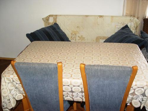 a table with two chairs and a table and a table and chairsuggest at Guesthouse Durmitor Magic in Žabljak