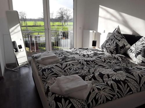 a bedroom with a large bed with a large window at Pleasant apartment in Ostbevern in Ostbevern