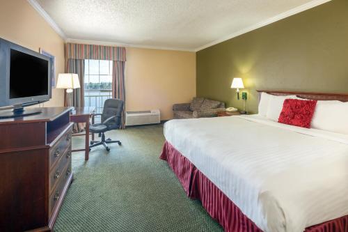 a hotel room with a bed and a desk and a television at Extend-a-Suites - Extended Stay, I-40 Amarillo West in Amarillo