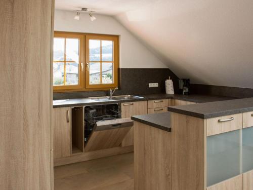 a kitchen with wooden cabinets and a sink at Holiday apartment Thoma in Königheim