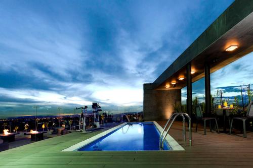 a swimming pool on the roof of a building at Hotel Estelar Parque de la 93 in Bogotá