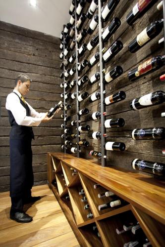 a man standing in front of a wine cellar at Hotel Estelar Parque de la 93 in Bogotá