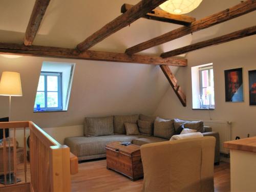 a living room with a couch and a table at Chic Apartment in Thuringia with Sauna in Hamma