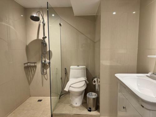 a bathroom with a shower and a toilet and a sink at Condo Minium Patong Phuket in Patong Beach