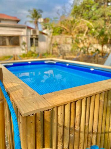 a swimming pool on a wooden deck with at Camp Baroro in Bacnotan