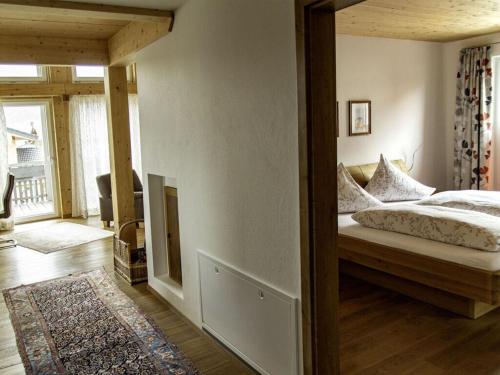 a bedroom with a bed and a large mirror at Nice apartment in Bolsterlang in Bolsterlang