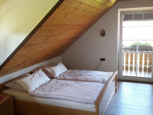 a bedroom with a bed with a wooden roof at Holiday apartment Schupp in Wittenschwand