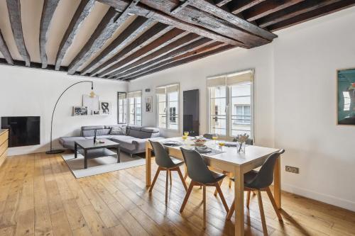 een woonkamer met een tafel en stoelen bij Les Halles & Le Marais - CityApartmentStay in Parijs