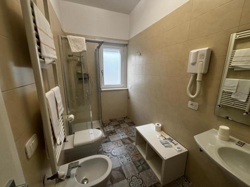 a bathroom with a sink and a toilet and a shower at La Nuova Dimora B&B in LʼAquila