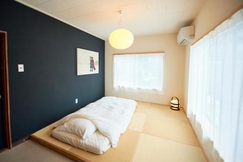 Tempat tidur dalam kamar di Aoyado - Tottori Aoya