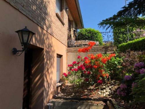 a brick building with a street light next to flowers at Holiday apartment Silberborth in Seesen