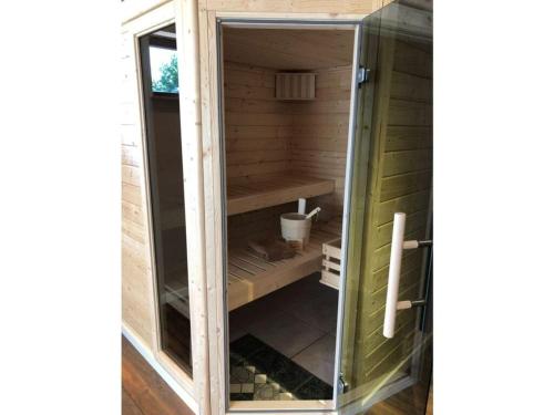 a wooden sauna with a glass door at Holiday apartment Silberborth in Seesen