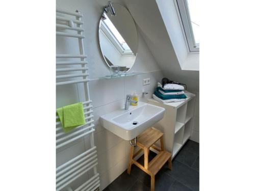 a bathroom with a sink and a mirror at Holiday apartment feel-good time in Markdorf