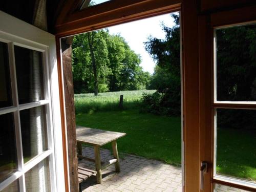 an open door to a patio with a bench outside at Holiday home Hirtenkate apartment 2 in Gödenstorf