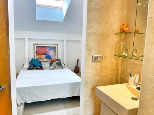 a bedroom with a bed and a bathroom at Ojen Penthouse in Ojén
