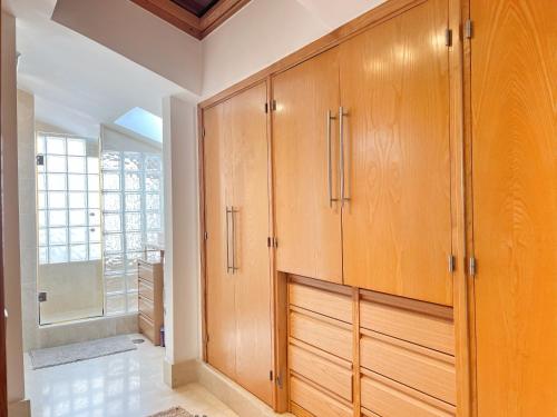 a large closet with wooden cabinets in a room at Ojen Penthouse in Ojén