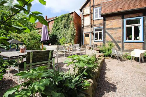 a garden with a table and chairs and an umbrella at Apartment Plau am See in Plau am See