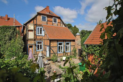 an old brick house with a garden in front of it at Apartment Plau am See in Plau am See