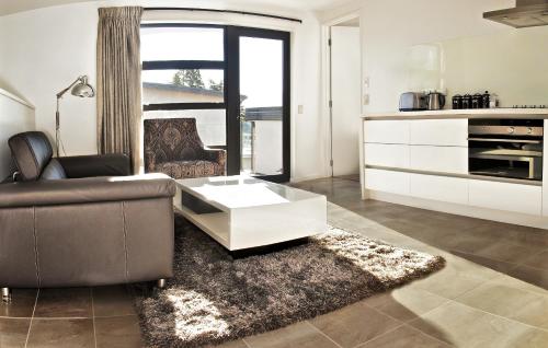 a living room with a couch and a coffee table at Apartments on Upton in Wanaka
