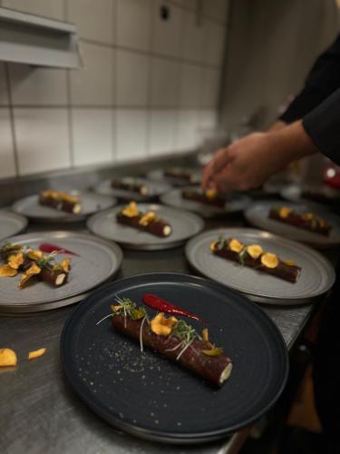 a row of plates of food on a counter at Best Western Hotel Botnia in Umeå