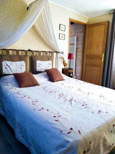 a bedroom with a large bed with red flowers on it at DUCK HOUSE in Saint-Wandrille-Rançon