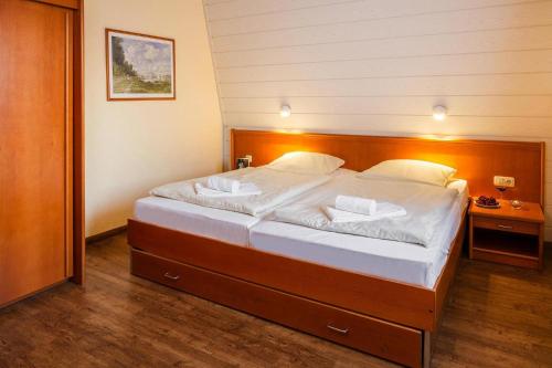 a bedroom with a large bed with white sheets at Semi detached houses in the Weissenh user Strand holiday and amusement park in Weissenhäuser Strand
