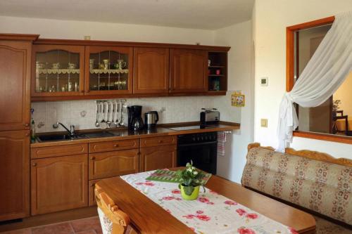 a kitchen with wooden cabinets and a wooden table with a table sidx sidx at Apartment view of fortress in Pirna in Pirna