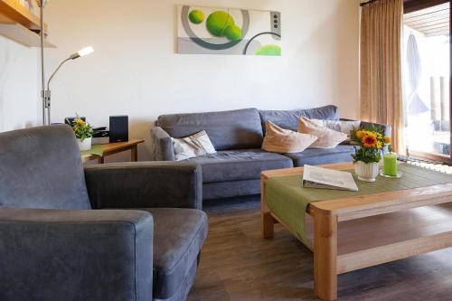 a living room with a couch and a coffee table at Holiday resort fingen Bad D rrheim in Bad Dürrheim