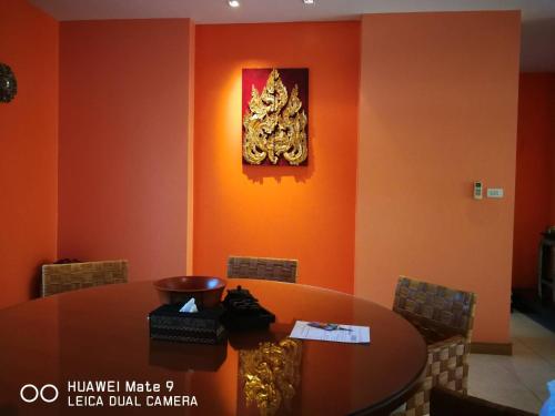 a dining room with a table and a picture on the wall at Hua Hin Blue Lagoon in Cha Am