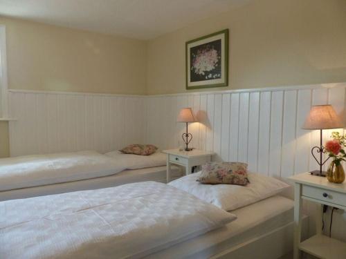 a bedroom with two beds and two tables with lamps at WERTS HOF Holiday home in Bracht