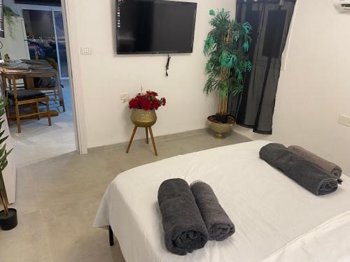 a room with a bed with towels on it at אחוזת מירבר in Tiberias