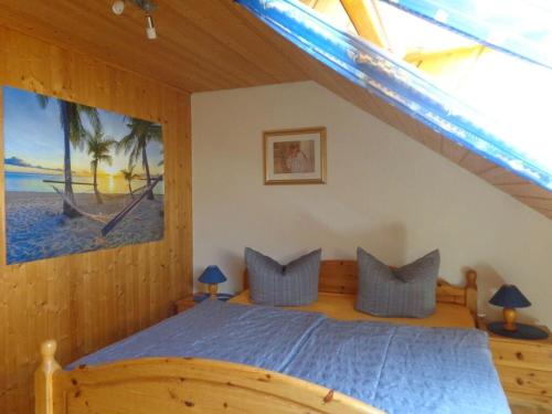 a bedroom with a bed with a blue comforter at Holiday apartment Haus Christa with balcony in Waldmünchen