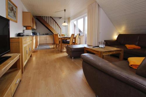 a living room with a couch and a dining room at Apartment house Katharina Westerland in Westerland (Sylt)