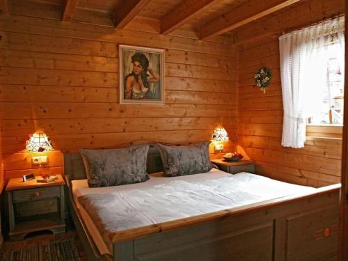 a bedroom with a bed in a log cabin at Holiday home Anja in Motten