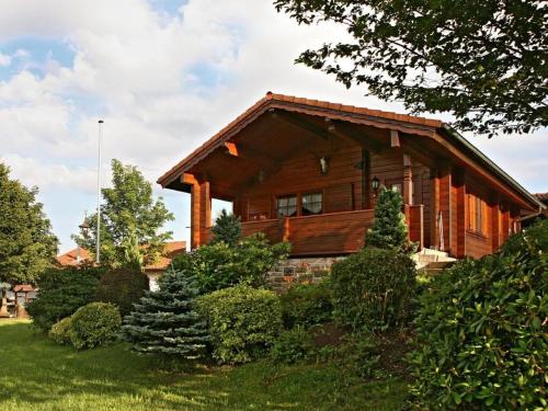 a log home with trees and bushes in front of it at Holiday home Anja in Motten in Motten