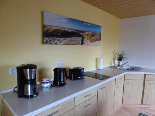 a kitchen with two coffee machines on a counter at Lovely Holiday Home in Bastorf Germany with Garden in Zweedorf