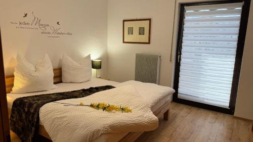 a bedroom with a bed with flowers on it at Ferienhaus Alexandra in Thyrnau in Thyrnau